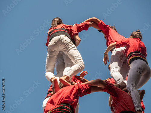 castellers in Catalunya exhibiting at the traditional yearly competition at la Merce celbration on Plaza San Jaume, Barcelona, Spain