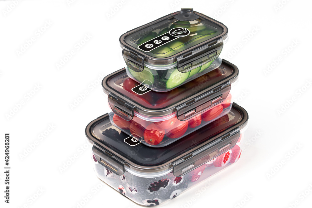 Closeup of plastic containers filled with tomatoes, cucumbers, blackberries, and strawberries Closeup of plastic containers filled with tomatoes, cucumbers, blackberries, and strawberries