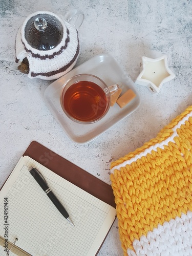 tea drinking, cup and teapot with tea on gray background