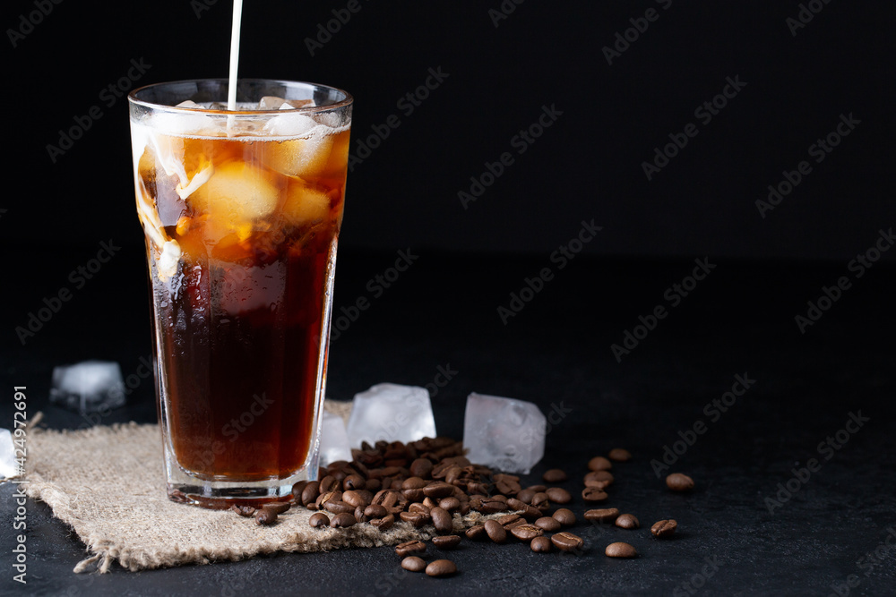 cold iced coffee brew with milk or cream on a black background coffee beans, summer drink cold iced coffee brew with milk or cream on a black background coffee beans, summer drink