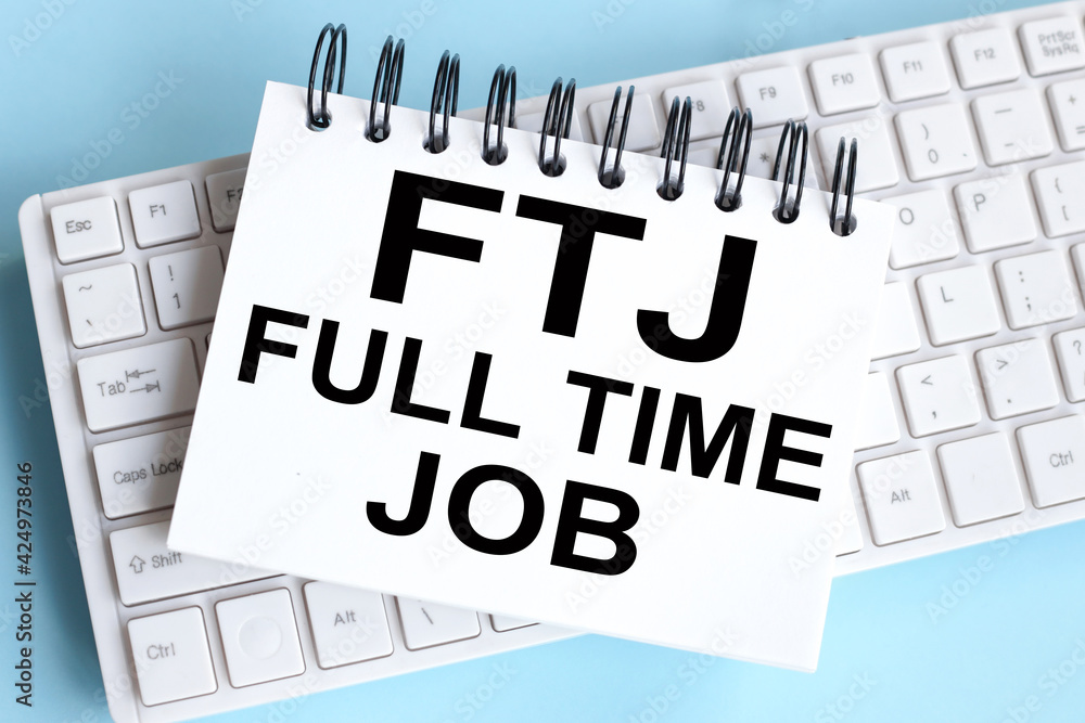 Full-time JOB message. FTJ. time to restart. text on white notepad paper on white keyboard Full-time JOB message. FTJ. time to restart. text on white notepad paper on white keyboard
