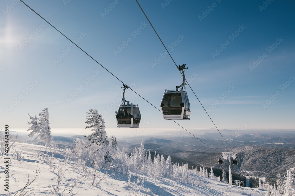 gondola ski lift in mountain ski resort, winter day, snowy spruce forest gondola ski lift in mountain ski resort, winter day, snowy spruce forest