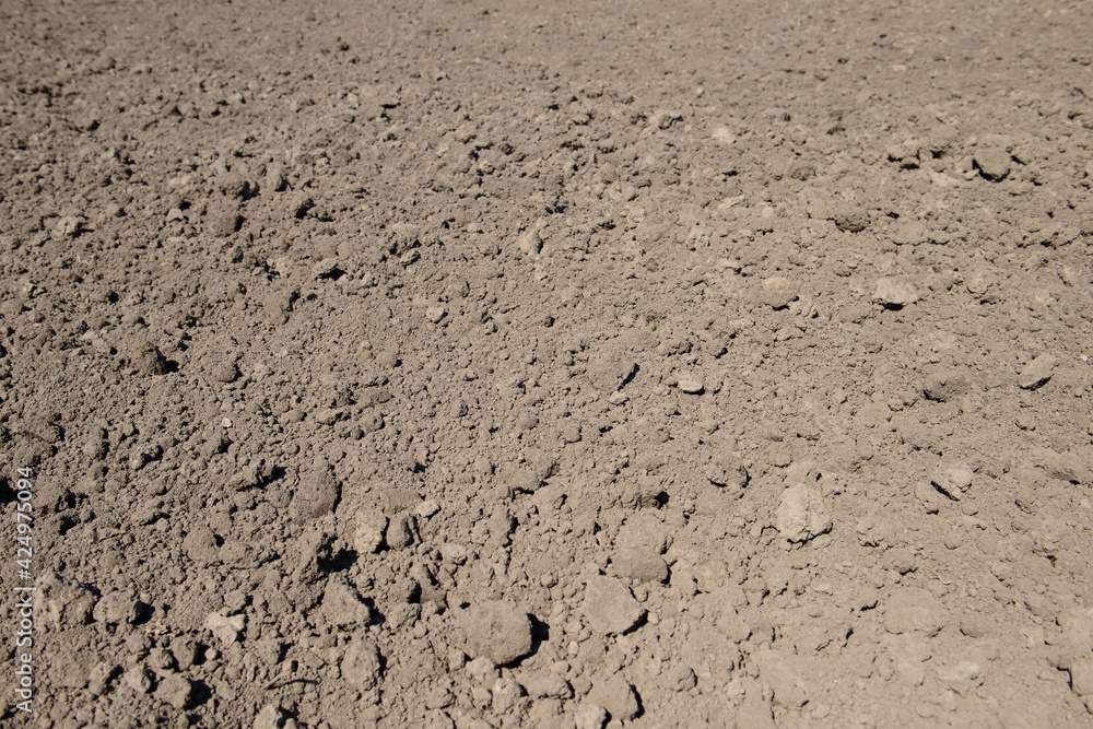 Ploughed brown clay soil agriculture fields ready to sow