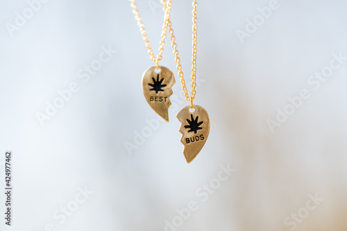 Quadro su tela Set of best friends best buds heart necklace shoot outside in a summer day closeup