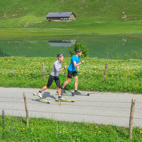 Zwei junge Langläufer beim Sommertraining auf Skirollern im klassischen Stil photo