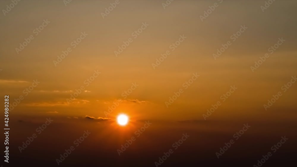 beautiful sunset sky time lapse, bright sun and dark silhouette of clouds as a background beautiful sunset sky time lapse, bright sun and dark silhouette of clouds as a background