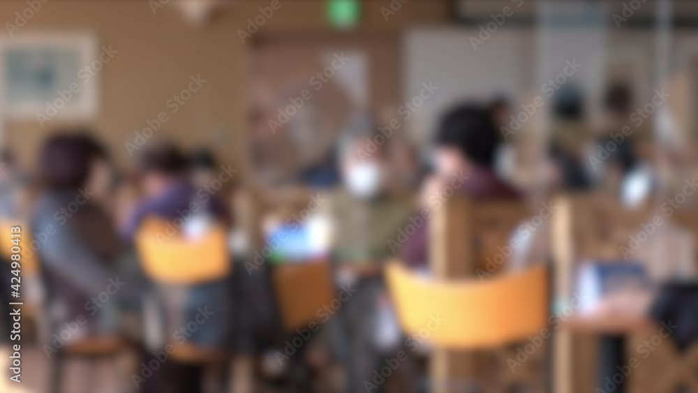 Blurred shot of people with mask chatting in a restaurant in Japan. 4K. March 22, 2021 Blurred shot of people with mask chatting in a restaurant in Japan. 4K. March 22, 2021