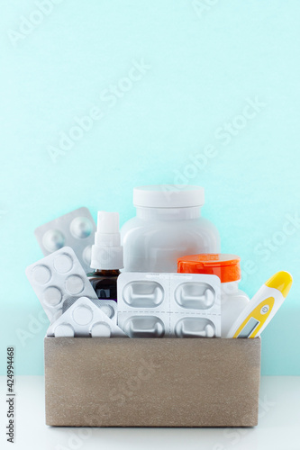 Image of a box of compounded prescription medications shipped from a mail order pharmacy on a lihgt blue background.