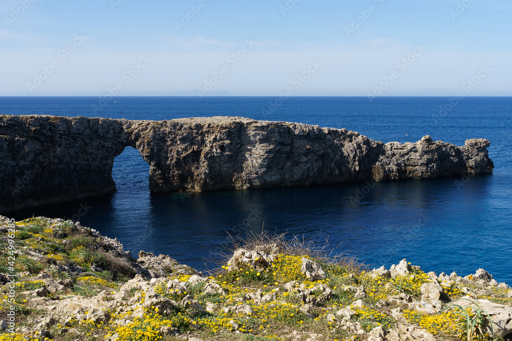 View of Pont d'en Gil, in Menorca (Balearic Islands, Spain), in a sunny day with blue sky View of Pont d'en Gil, in Menorca (Balearic Islands, Spain), in a sunny day with blue sky