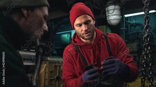Male technician showing detail to colleague © Framestock