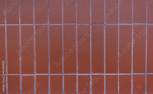 Background of brown ceramic tiles. Full frame image of brown ceramic tile wall background