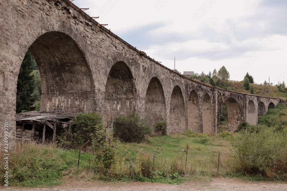 Old railway bridge, old viaduct Vorokhta, Ukraine. Carpathian Mountains, wild mountain landscape