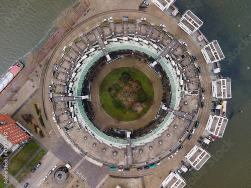 A circle shaped building resident housing aerial drone view.