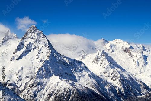 Beautiful snowy mountains and blue sky Dombay Karachay-Cherkessia