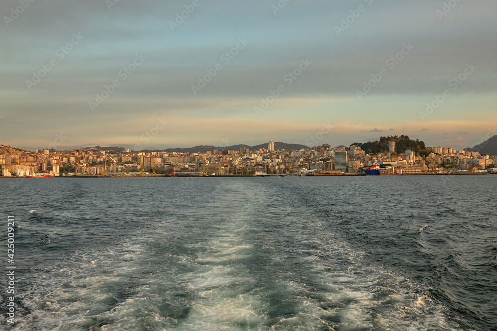 View of the rear of a ship moving away from the port of the city of Vigo in Galicia, Spain.