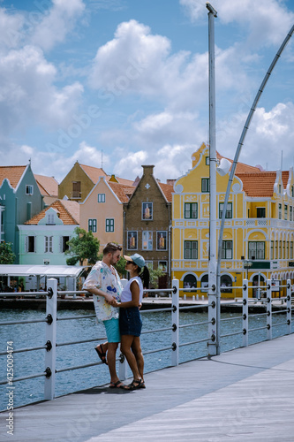 Curacao, Netherlands Antilles View of colorful buildings of downtown Willemstad Curacao Caribbean Island, couple men and woman mid age visiting Willemstad photo