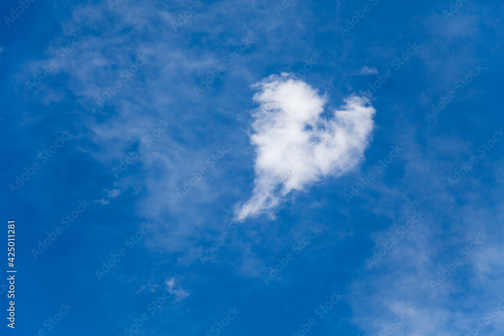 Heart shaped cloud. Blue sky background. Concept of love Heart shaped cloud. Blue sky background. Concept of love
