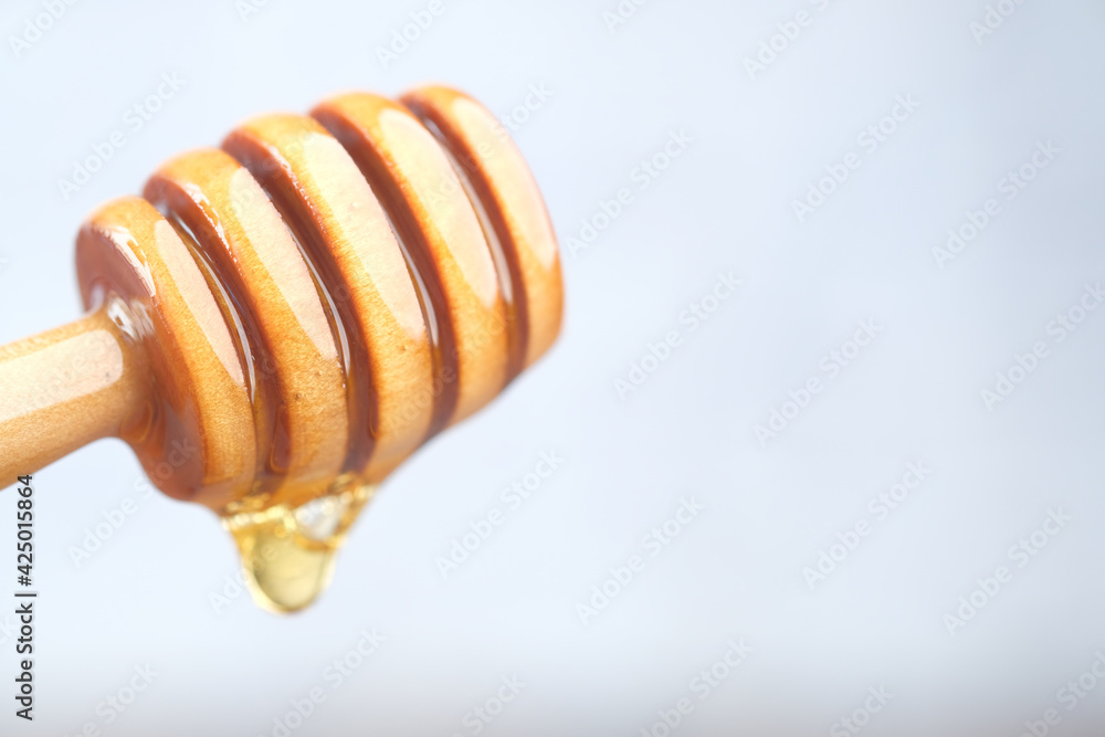 close up of fresh honey with spoon isolated on white close up of fresh honey with spoon isolated on white