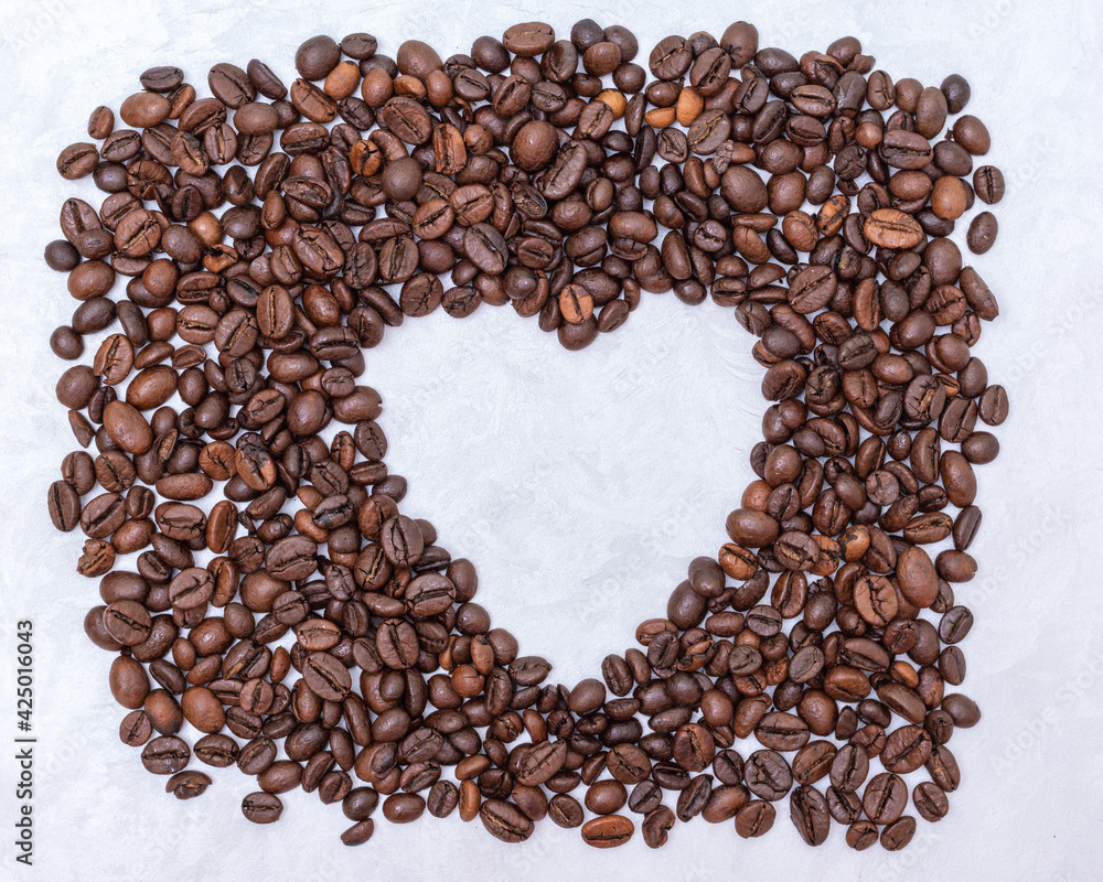 Heart coffee frame made of coffee beans on white stucco background, top view, copy space. Coffee love concept Heart coffee frame made of coffee beans on white stucco background, top view, copy space. Coffee love concept