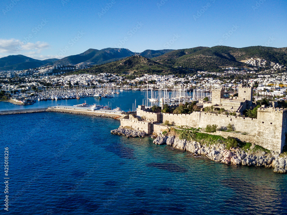Amazing panoramic view from drone of beautiful full of yachts Bodrum harbour and ancient Kalesi castle in Mugla province in Turkey
