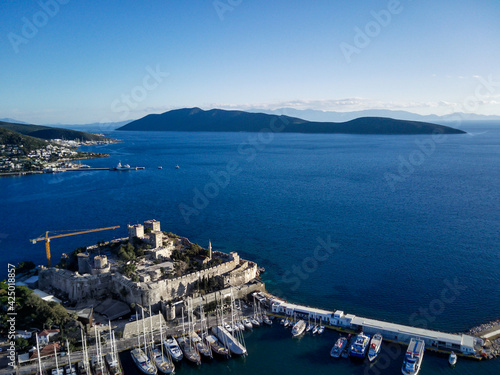 Amazing panoramic view from drone of beautiful full of yachts Bodrum harbour and ancient Kalesi castle in Mugla province in Turkey 