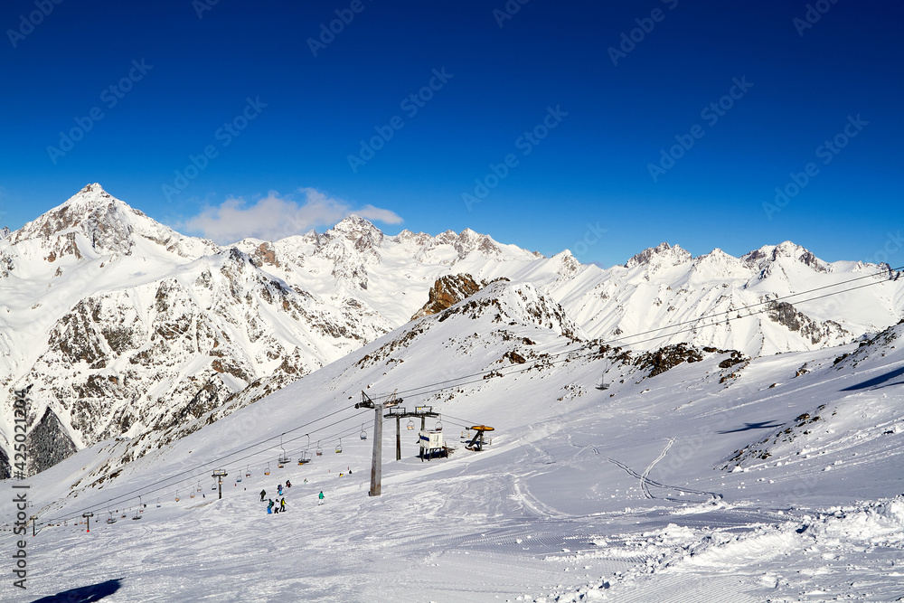 Beautiful snowy mountains and blue sky Dombay Karachay-Cherkessia