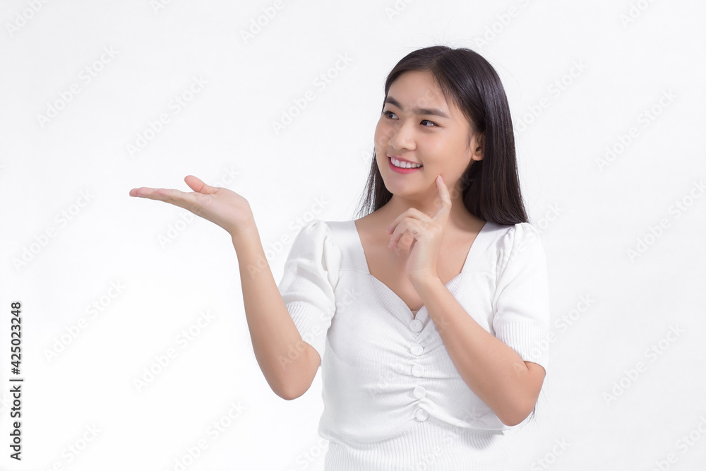 Asian beautiful woman with black long hair wearing a white shirt and pretty smiling is present product on white background. Asian beautiful woman with black long hair wearing a white shirt and pretty smiling is present product on white background.