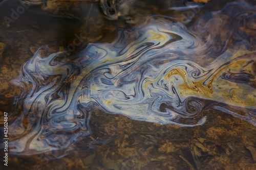 Cuadro en lienzo oil spills on puddle background, abstract gasoline nature pollution concept