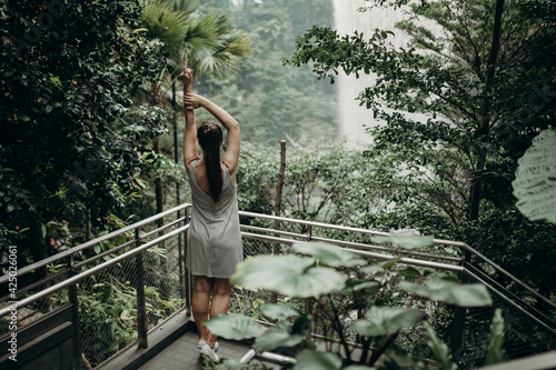 Photography Girl in the jungle overlooking the waterfall
