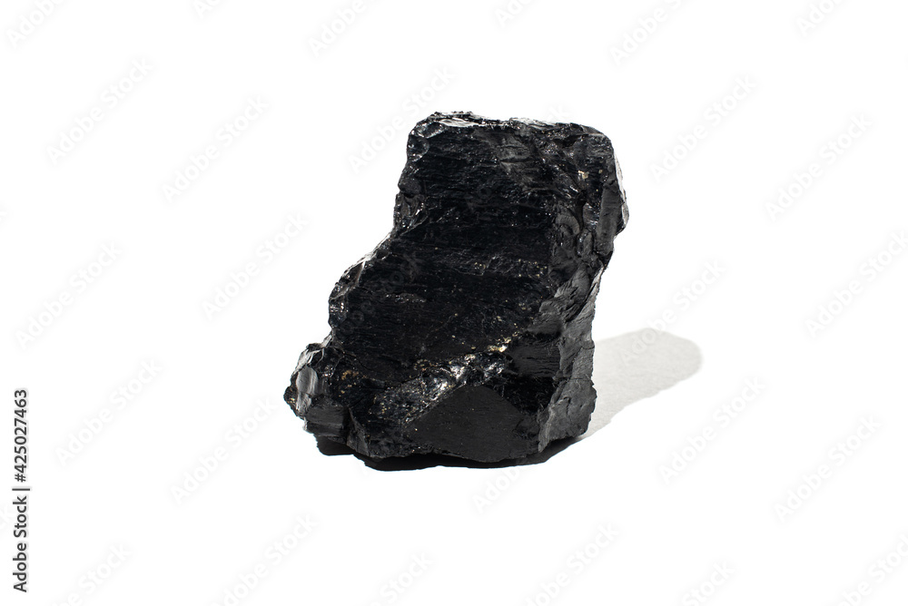 A piece of coal interspersed with copper pyrite on a white background. Natural black coal. A piece of coal interspersed with copper pyrite on a white background. Natural black coal.