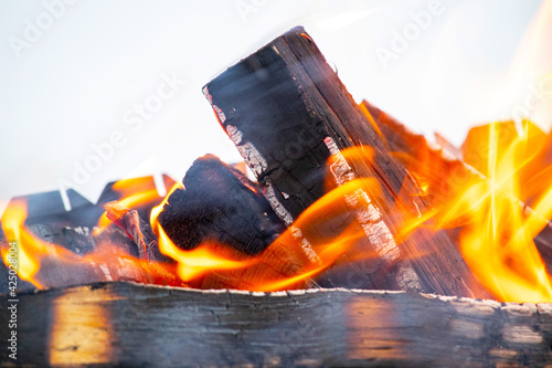 Fire. Firewood is burning in the grill. Orange firelight, sparks flying. Fire background. photo