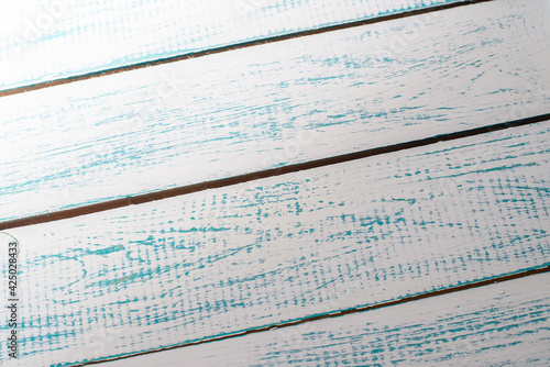 Antique blue and white wooden table top. Wooden wall background.