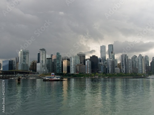 Skyline Downtown Vancouver seen from Stanley park seawall with dark clouds, Vancouver, British Columbia, Canada, stock photo