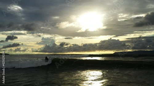 beautiful waves surfed by a man Costa Rican sunset pavones drone shot  photo