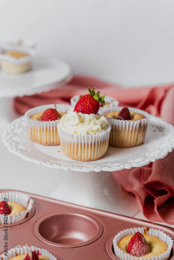 Muffins Cupcake cream decorated with colorful sprinkles on white background and strawberries 