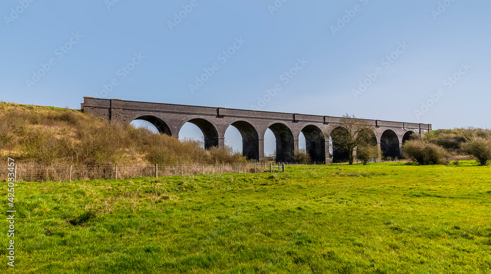 An oblique view towards the abandoned Helmdon viaduct on a bright Spring day
