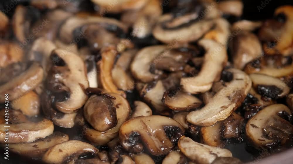 cooking mushrooms on pan close up. frying and stir mushrooms cooking mushrooms on pan close up. frying and stir mushrooms