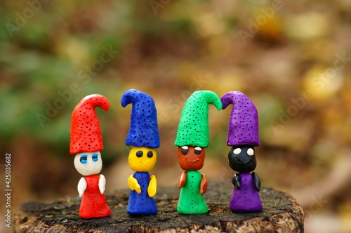 Figures of multi-colored gnomes on a colored background.