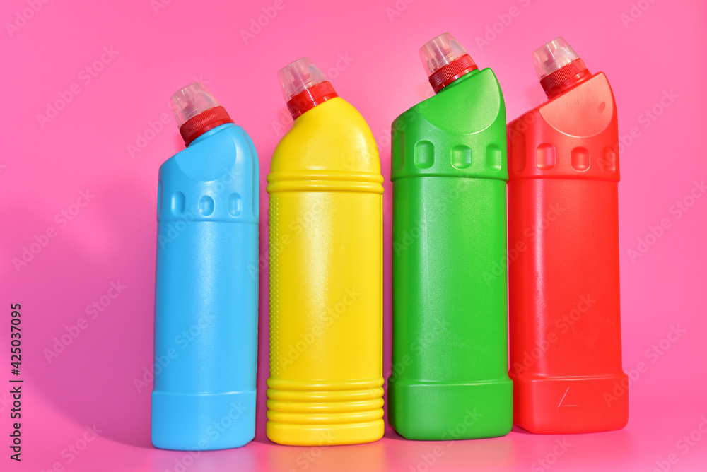 Detergent bottles on pink background. Detergents and laundry for cleaning. Household chemicals concept. Chemical liquid for washing. Concentrated and anti-bacterial liquids for dishwasher Detergent bottles on pink background. Detergents and laundry for cleaning. Household chemicals concept. Chemical liquid for washing. Concentrated and anti-bacterial liquids for dishwasher