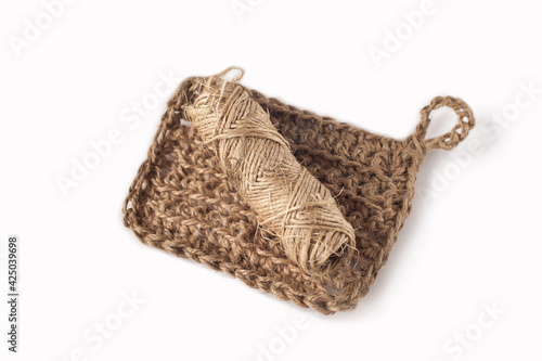 A washcloth made of craft thread for bathing. The concept of waste-free production