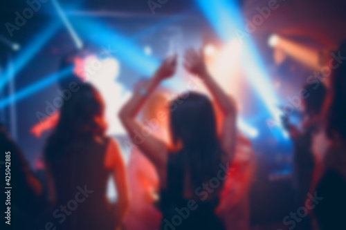 Silhouettes of a crowd on show in night club celebration. Blurred  bokeh  background  restaurant.