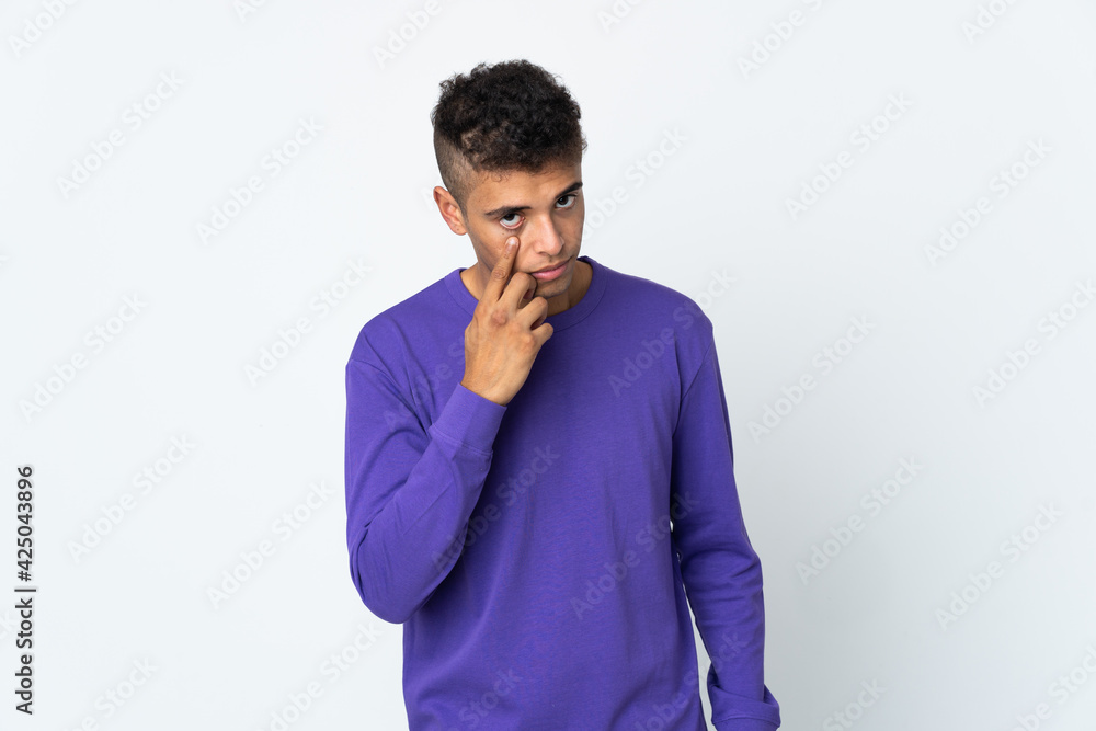 Young brazilian man isolated on white background showing something Young brazilian man isolated on white background showing something