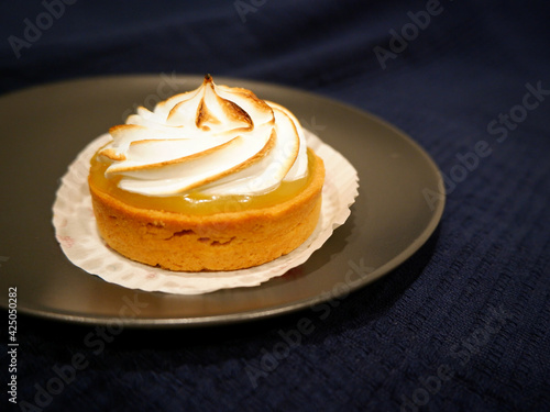 Lemon meringue tart on the right with a copy space