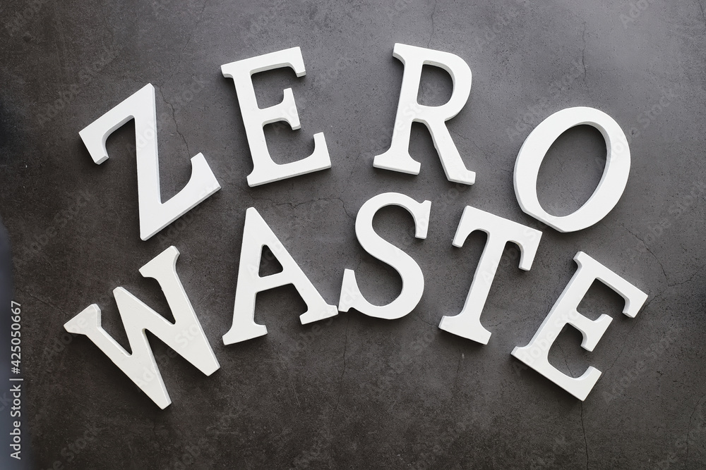 The concept of proper and environmental health. The inscription on black background with wooden letters and paper elements. Free GMO. Zero waste. The concept of proper and environmental health. The inscription on black background with wooden letters and paper elements. Free GMO. Zero waste.