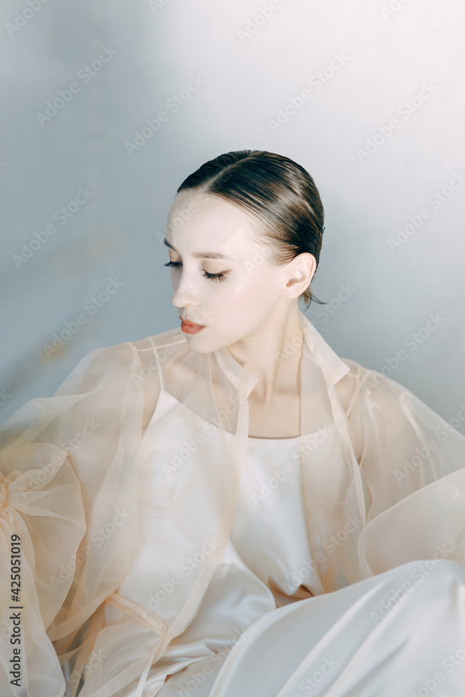 Fashion art photo of a young sensual lady in a flying dress. A beautiful girl poses in the studio, in the style of fine art. Fashion art photo of a young sensual lady in a flying dress. A beautiful girl poses in the studio, in the style of fine art.