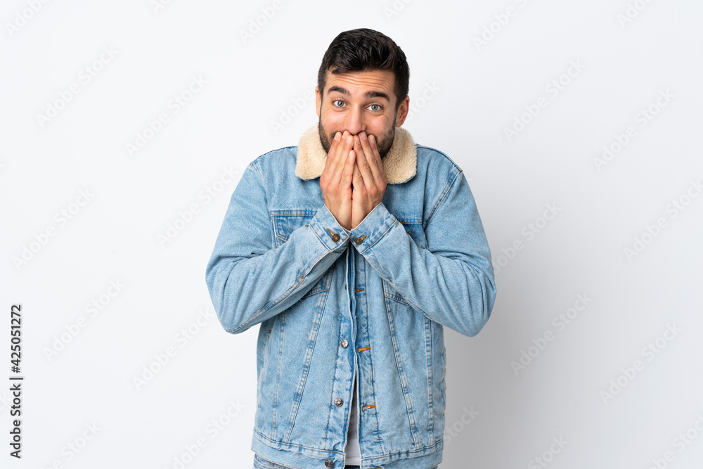 Young handsome man with beard isolated on white background happy and smiling covering mouth with hands Young handsome man with beard isolated on white background happy and smiling covering mouth with hands