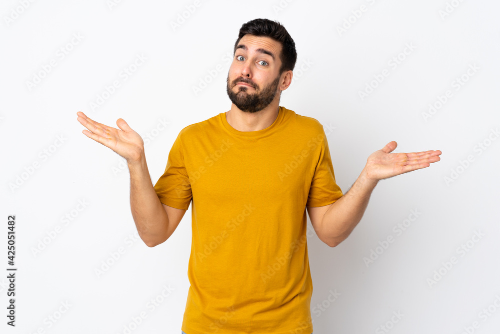 Young handsome man with beard isolated on white background making doubts gesture Young handsome man with beard isolated on white background making doubts gesture