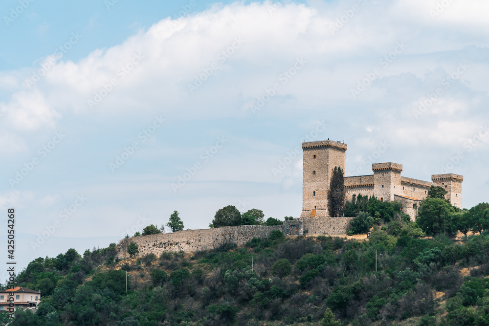 Narni, Umbria, Italy - The medieval castle of the ancient village of Narni. The blue sky in summer. The stone walls and towers of the fortress.