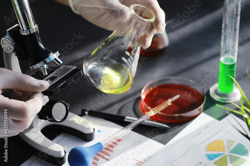 Laboratory research. Drug testing. Chemical experiments in the laboratory. Microscope various test tubes and beakers on the table at the medical officer.
