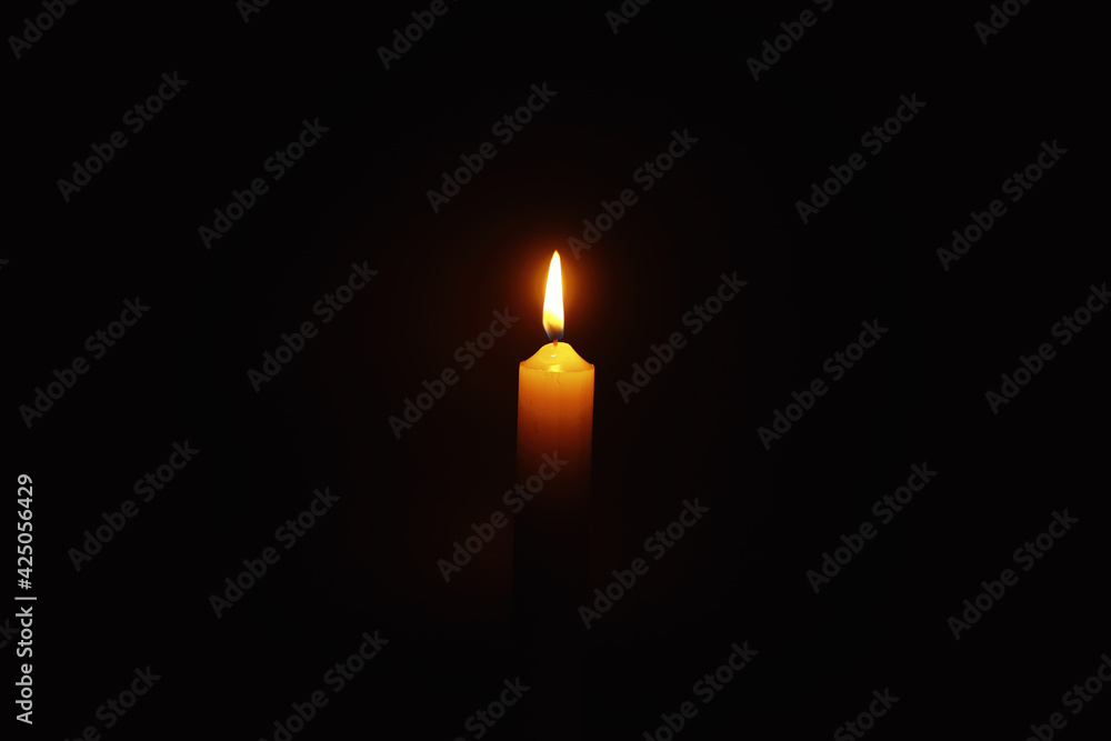 Burning candle Wick from a candle in a flame of fire. Symbol of sadness and loneliness. A time of condolences. Burning wax candle. Religion. Burning candle Wick from a candle in a flame of fire. Symbol of sadness and loneliness. A time of condolences. Burning wax candle. Religion.